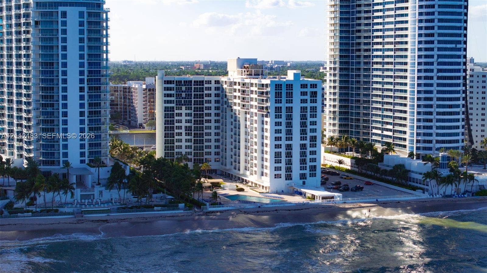 3505 S Ocean Drive, #1101, Hollywood, FL 33019 High-rise multi-story building exterior with balcony access, ground-level swimming pool, and direct coastal frontage
