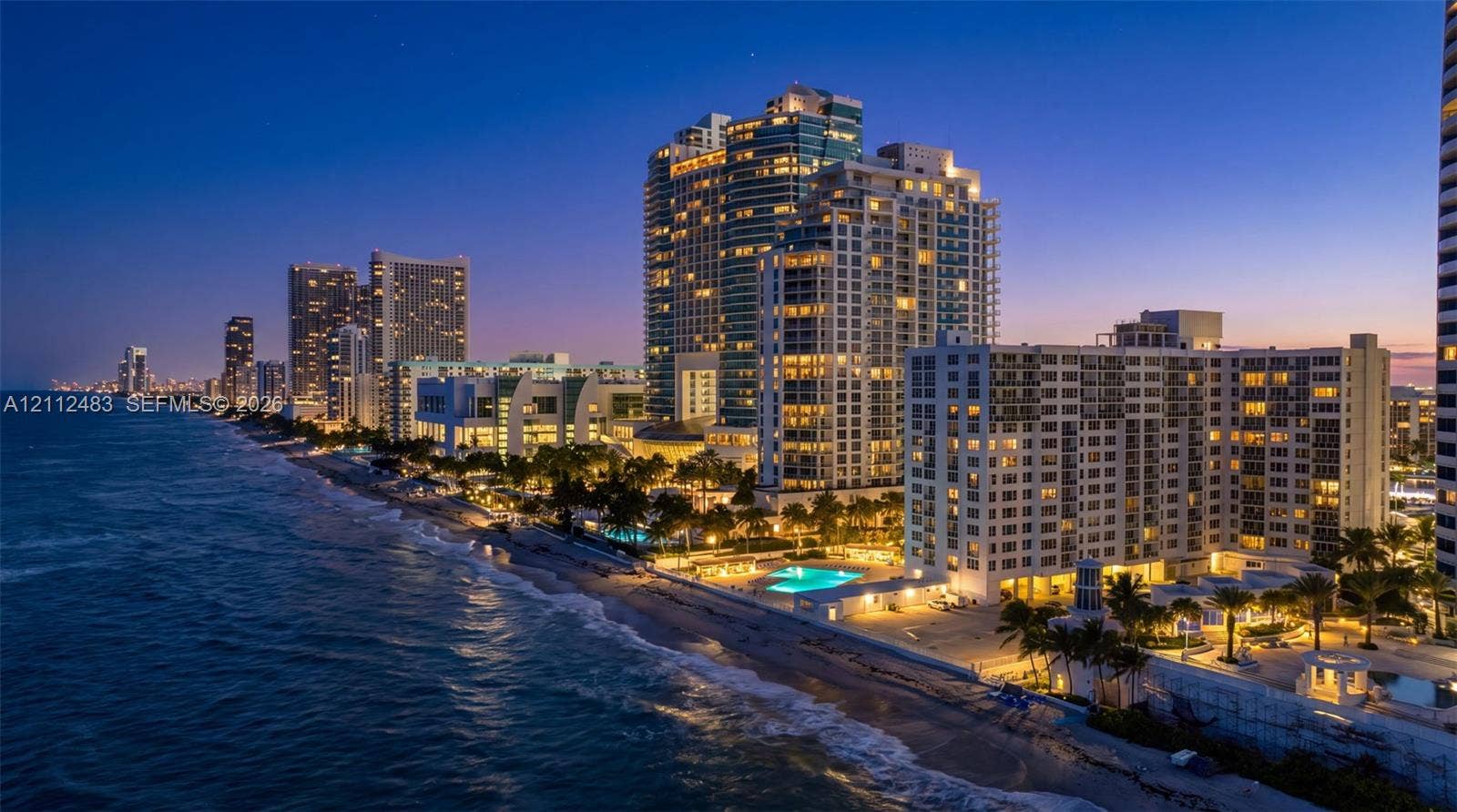 3505 S Ocean Drive, #1101, Hollywood, FL 33019 High-rise residential tower featuring direct oceanfront access, exterior balconies, landscaped grounds, and a paved pool deck with outdoor swimming pool