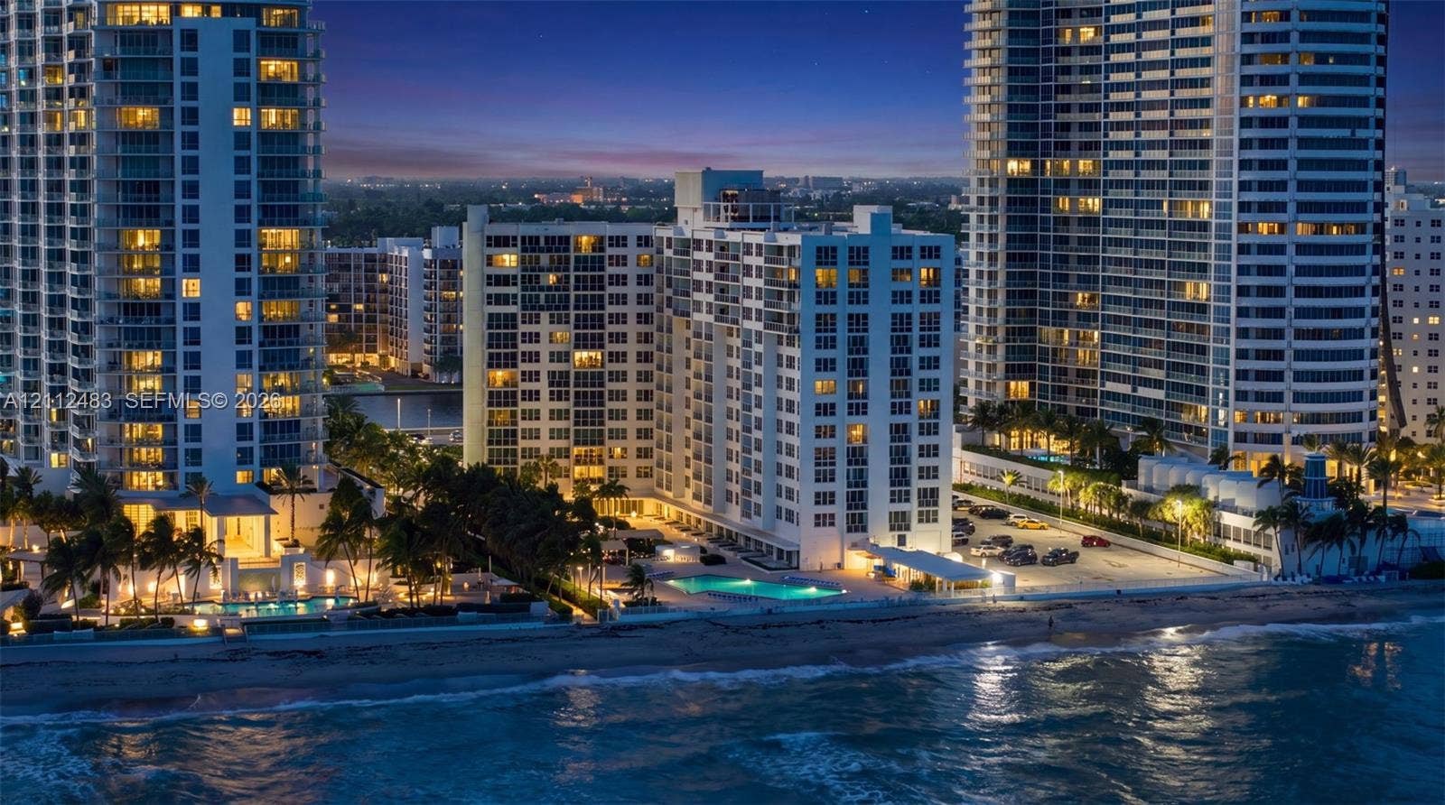 3505 S Ocean Drive, #1101, Hollywood, FL 33019 High-rise residential exterior with direct oceanfront access, exterior balconies, and a ground-level swimming pool