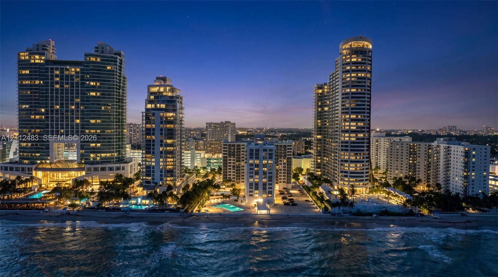 3505 S Ocean Drive, #1101, Hollywood, FL 33019 Coastal high-rise residential complex featuring oceanfront positioning, multiple swimming pools, and landscaped grounds with mature palm trees
