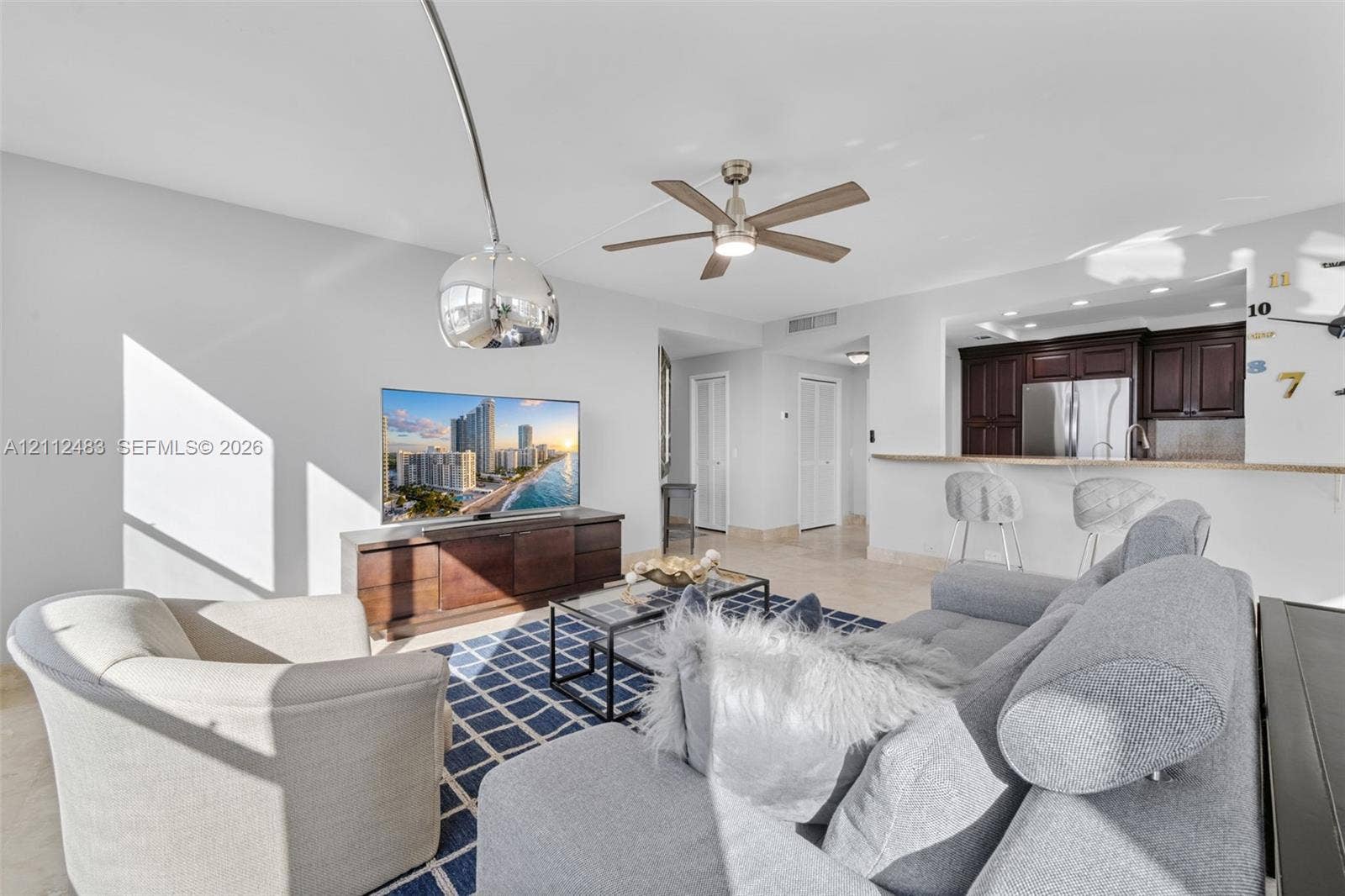 3505 S Ocean Drive, #1101, Hollywood, FL 33019 Open-concept space featuring recessed lighting, a modern ceiling fan, tile flooring, and kitchen cabinetry with a breakfast bar