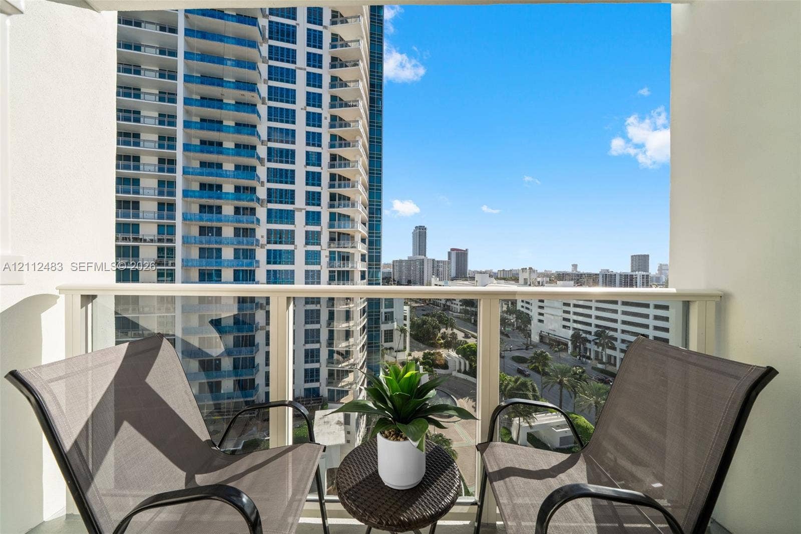 3505 S Ocean Drive, #1101, Hollywood, FL 33019 Private balcony featuring a glass panel railing and high-rise urban surroundings