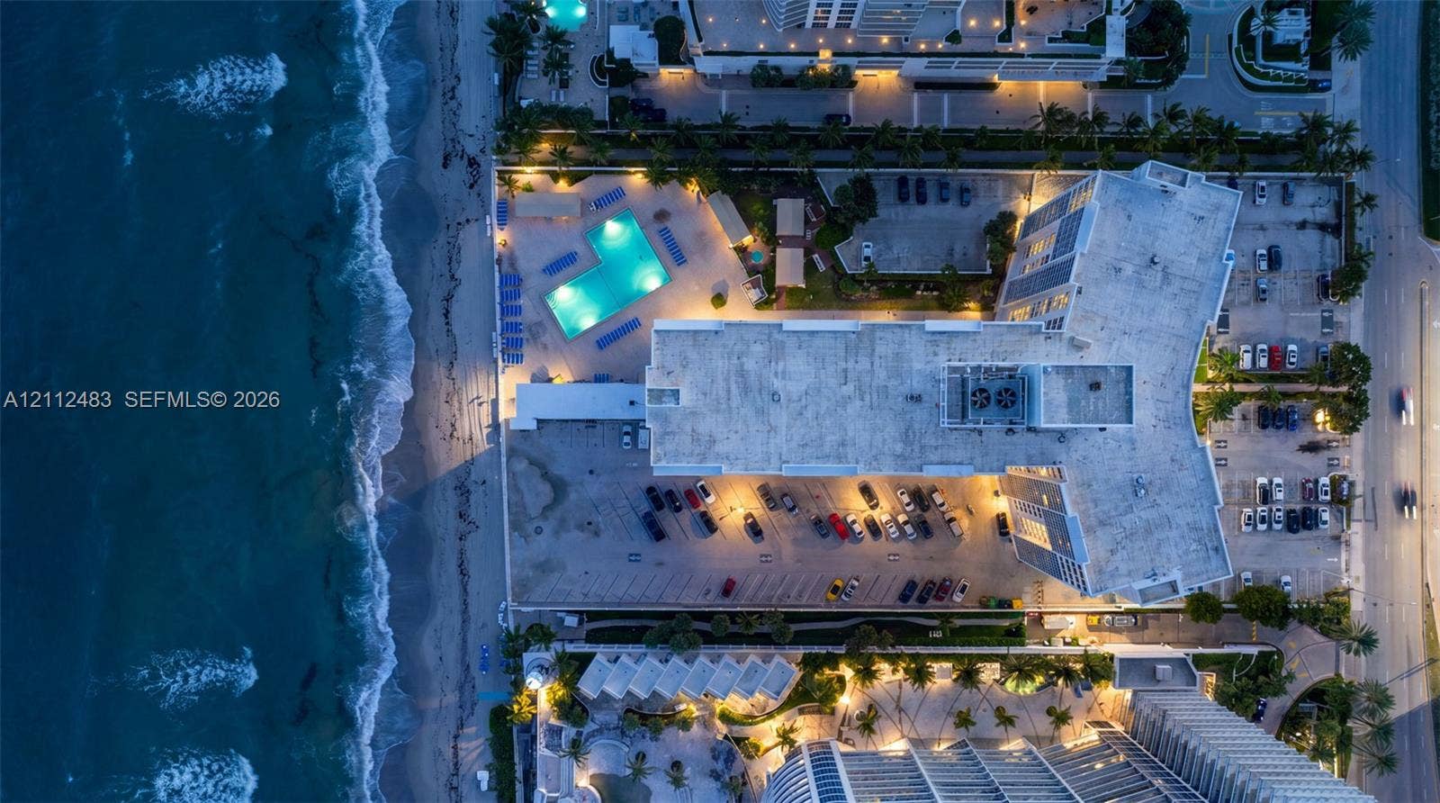 3505 S Ocean Drive, #1101, Hollywood, FL 33019 Aerial perspective of an oceanfront property featuring a swimming pool, direct shoreline access, and surface parking
