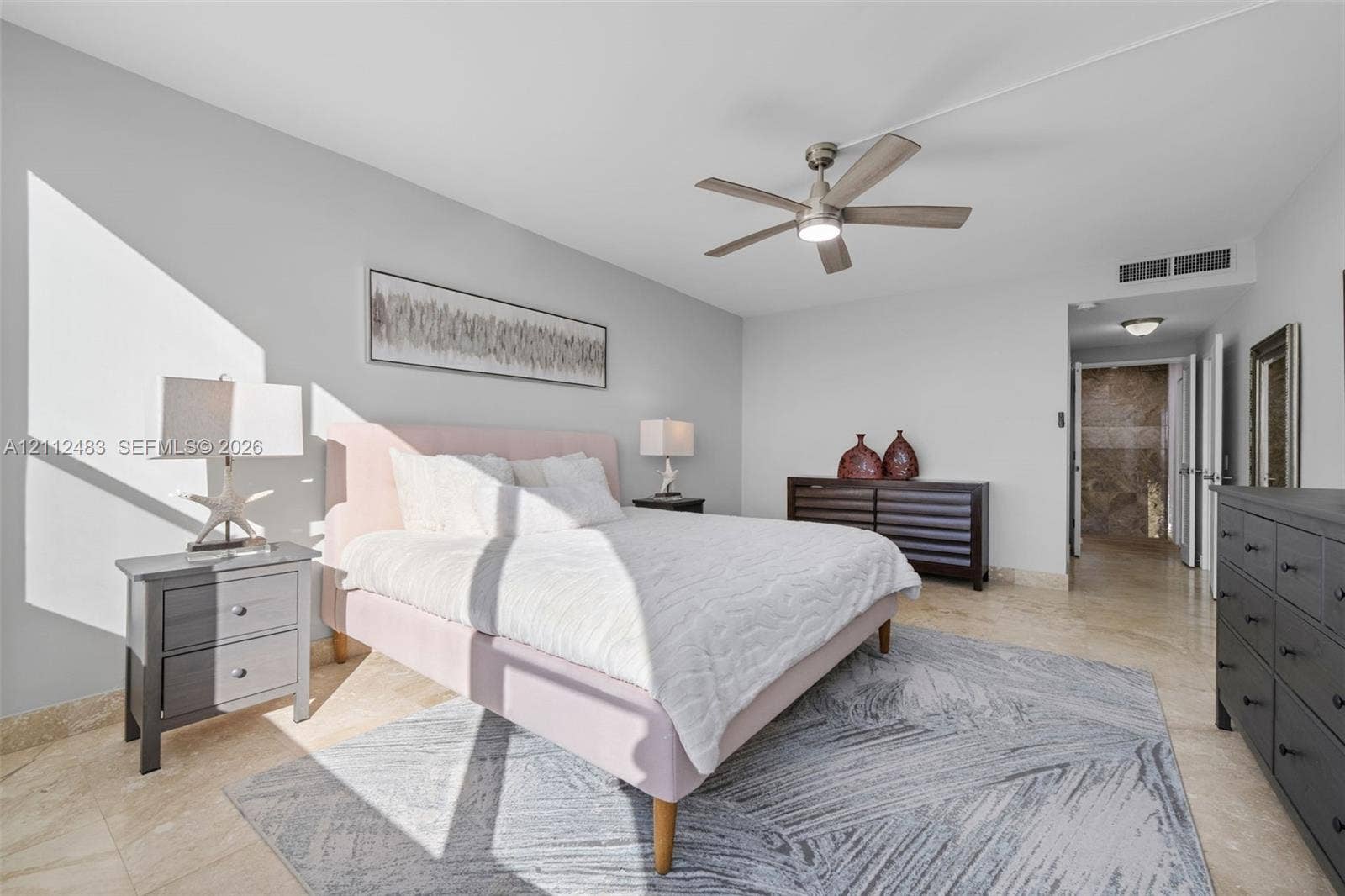 3505 S Ocean Drive, #1101, Hollywood, FL 33019 Neutral-toned room featuring large-format tile flooring, a brushed nickel ceiling fan with integrated lighting, and smooth-finish walls