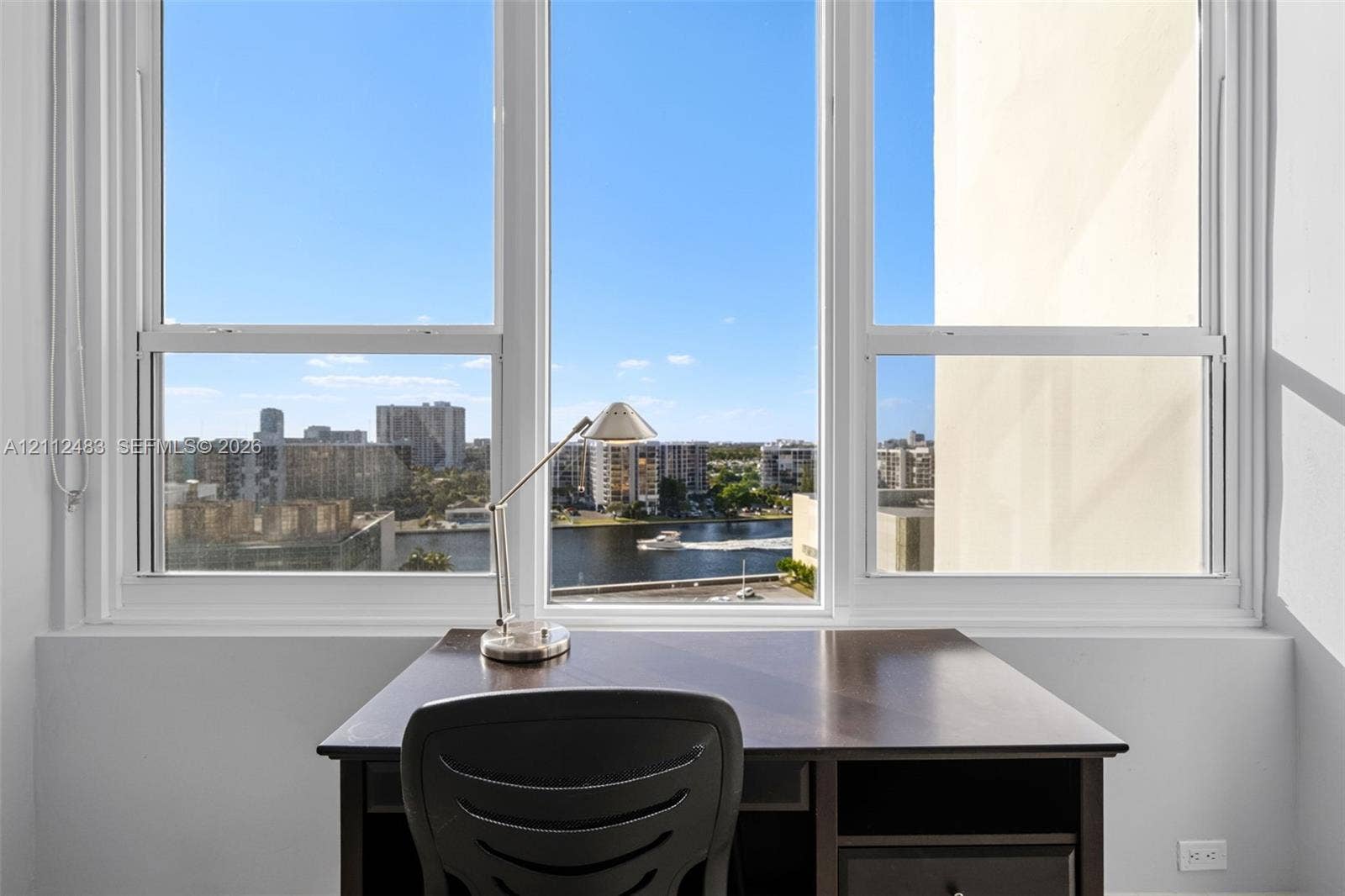 3505 S Ocean Drive, #1101, Hollywood, FL 33019 Large multi-pane window with white framing, providing natural light and exterior water and cityscape scenery