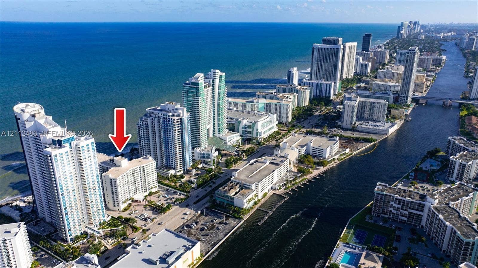 3505 S Ocean Drive, #1101, Hollywood, FL 33019 Aerial perspective of a high-rise residential building situated on the Atlantic coastline, featuring immediate proximity to the ocean, coastal waterway access, and urban infrastructure