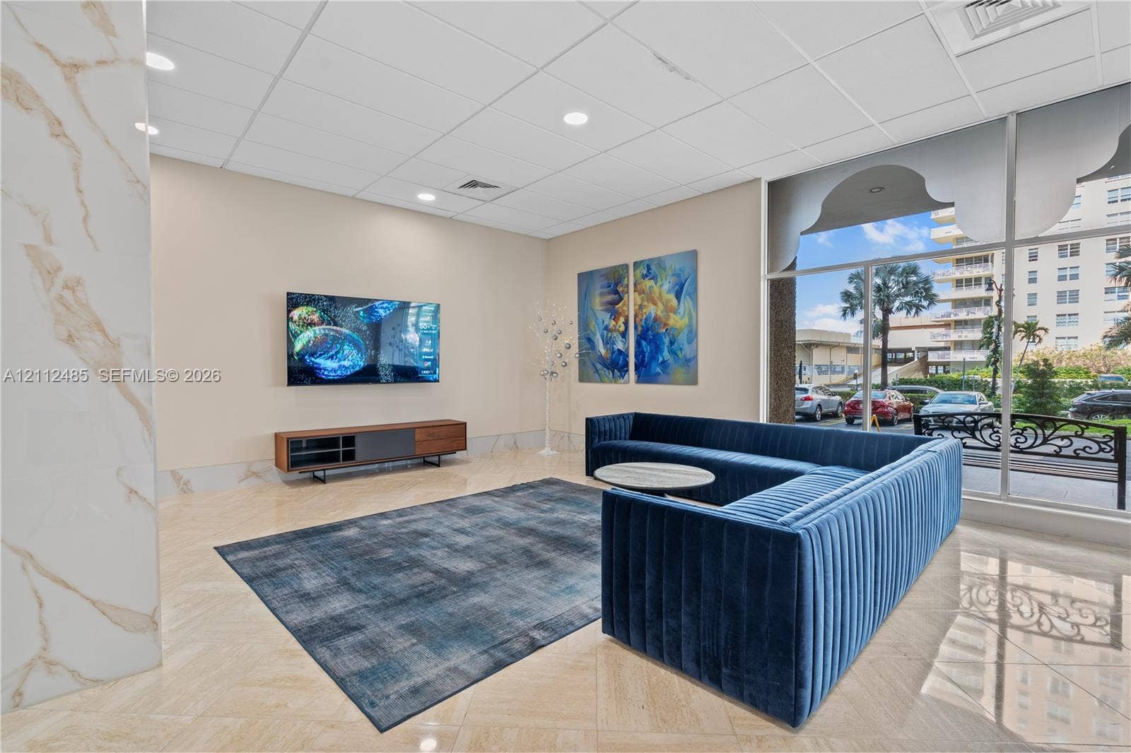 250 174th Street, #1707, Sunny Isles Beach, Sunny Isles Beach, FL 33160 Common area featuring polished stone tile flooring, floor-to-ceiling glass windows, recessed ceiling lighting, and a column accented with decorative stone cladding