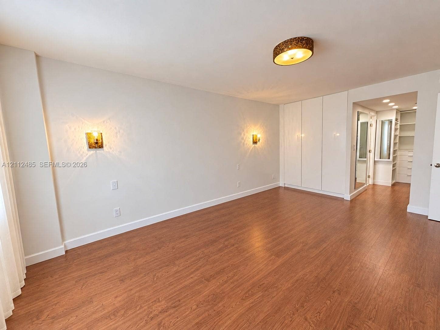 250 174th Street, #1707, Sunny Isles Beach, Sunny Isles Beach, FL 33160 Wood-finish flooring, built-in floor-to-ceiling cabinetry, recessed lighting, and wall-mounted sconces