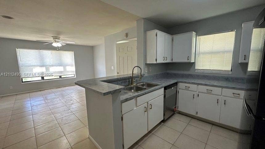 4025 NW 87th Avenue, #4025, Sunrise, Sunrise, FL 33351 Kitchen featuring white cabinetry, solid-surface countertops, dual-basin stainless steel sink, and tile flooring