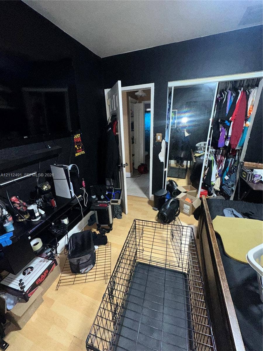 2509 Grant Street, Hollywood, FL 33020 Wood-finish flooring and a built-in sliding-door mirrored closet