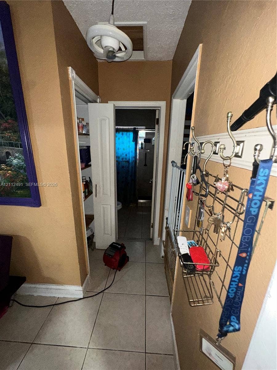 2509 Grant Street, Hollywood, FL 33020 Ceramic tile flooring, built-in storage closet with shelving, and overhead lighting