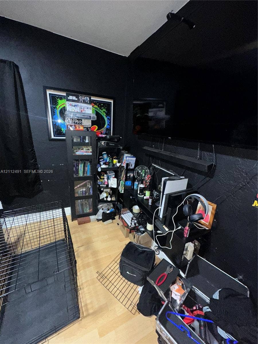 2509 Grant Street, Hollywood, FL 33020 Room featuring solid-color black wall finish and wood-finish flooring