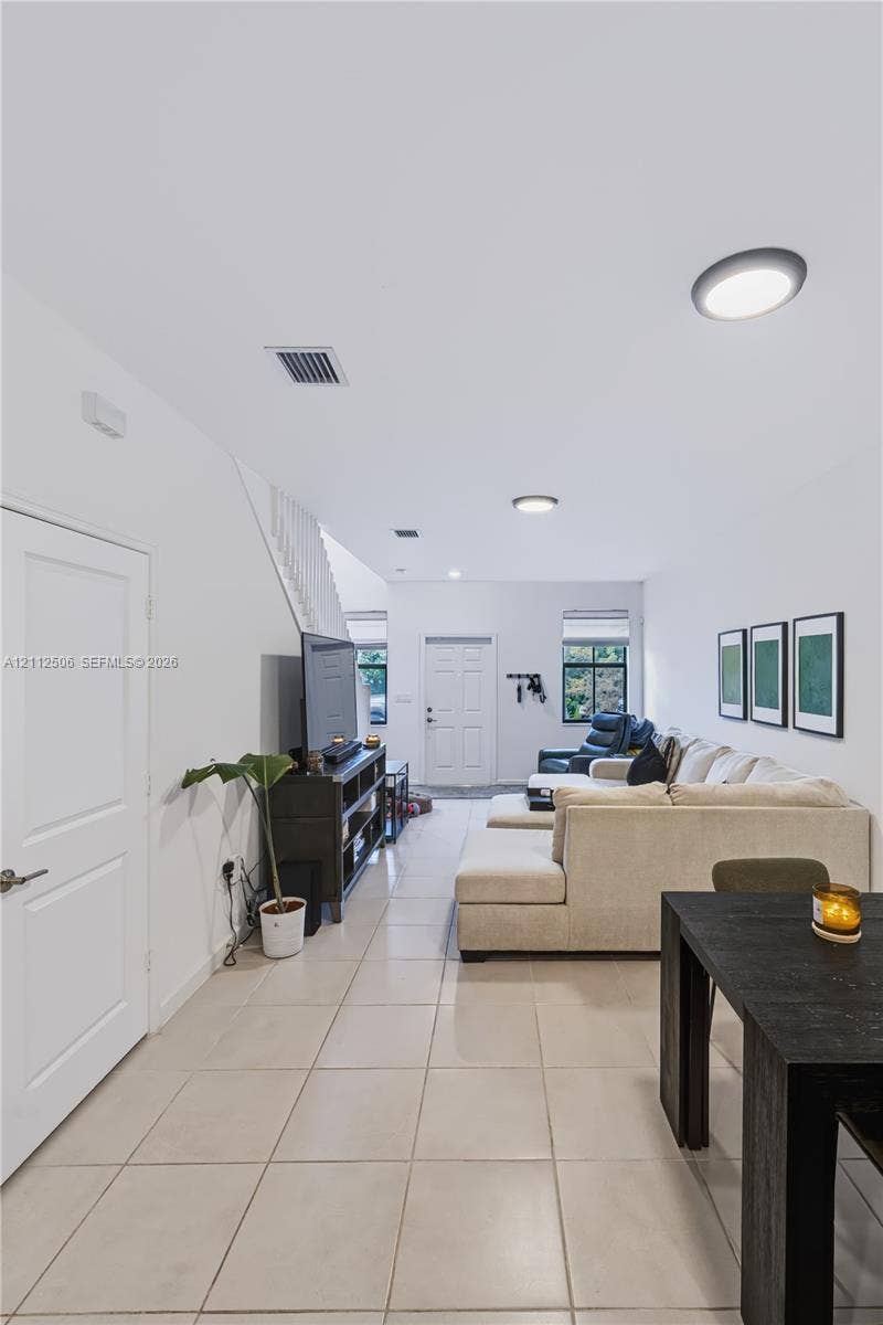 538 SW 19th Terrace, Fort Lauderdale, Fort Lauderdale, FL 33312 Open interior space featuring light-colored tile flooring, flush-mount circular lighting, and a white paneled entry door