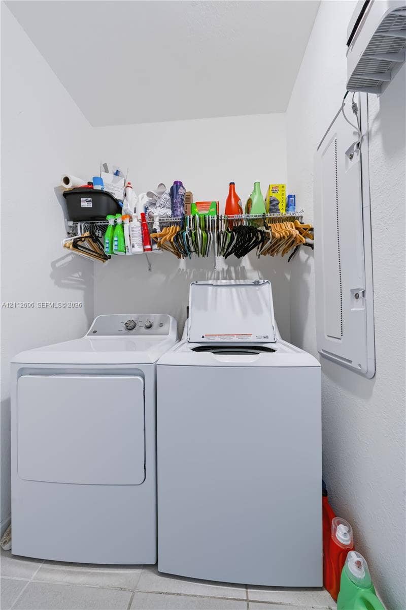 538 SW 19th Terrace, Fort Lauderdale, Fort Lauderdale, FL 33312 Dedicated laundry area featuring tile flooring, wall-mounted wire shelving, and a white breaker panel