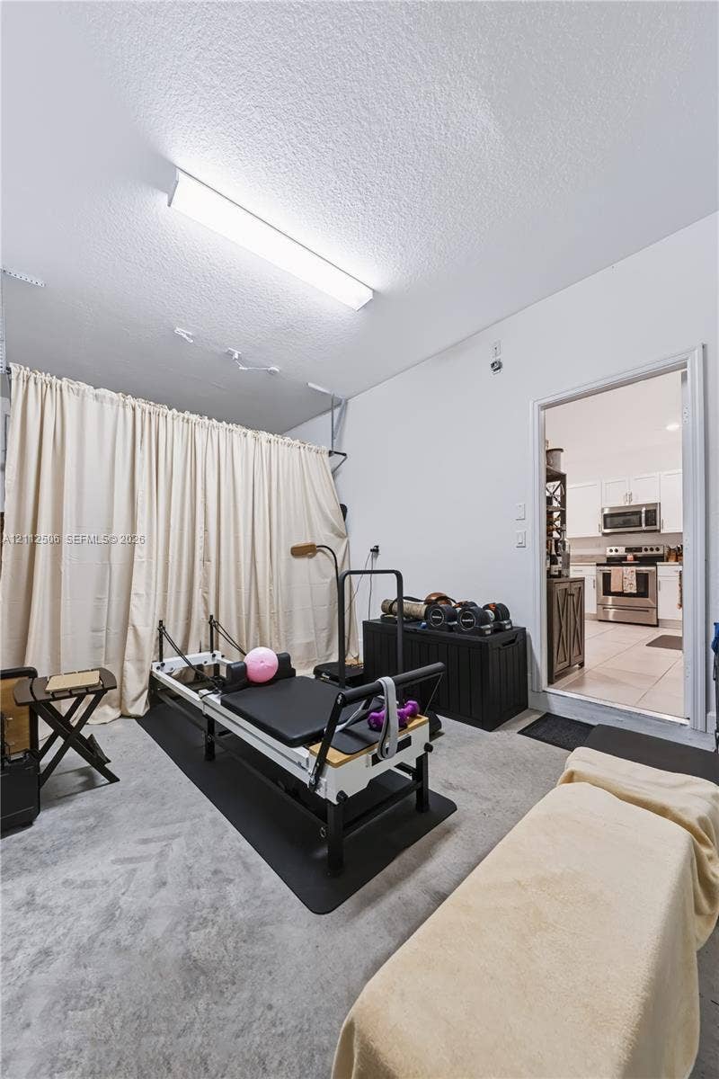 538 SW 19th Terrace, Fort Lauderdale, Fort Lauderdale, FL 33312 Flex space featuring concrete flooring, wall-mounted linear lighting, and a floor-to-ceiling curtain track system