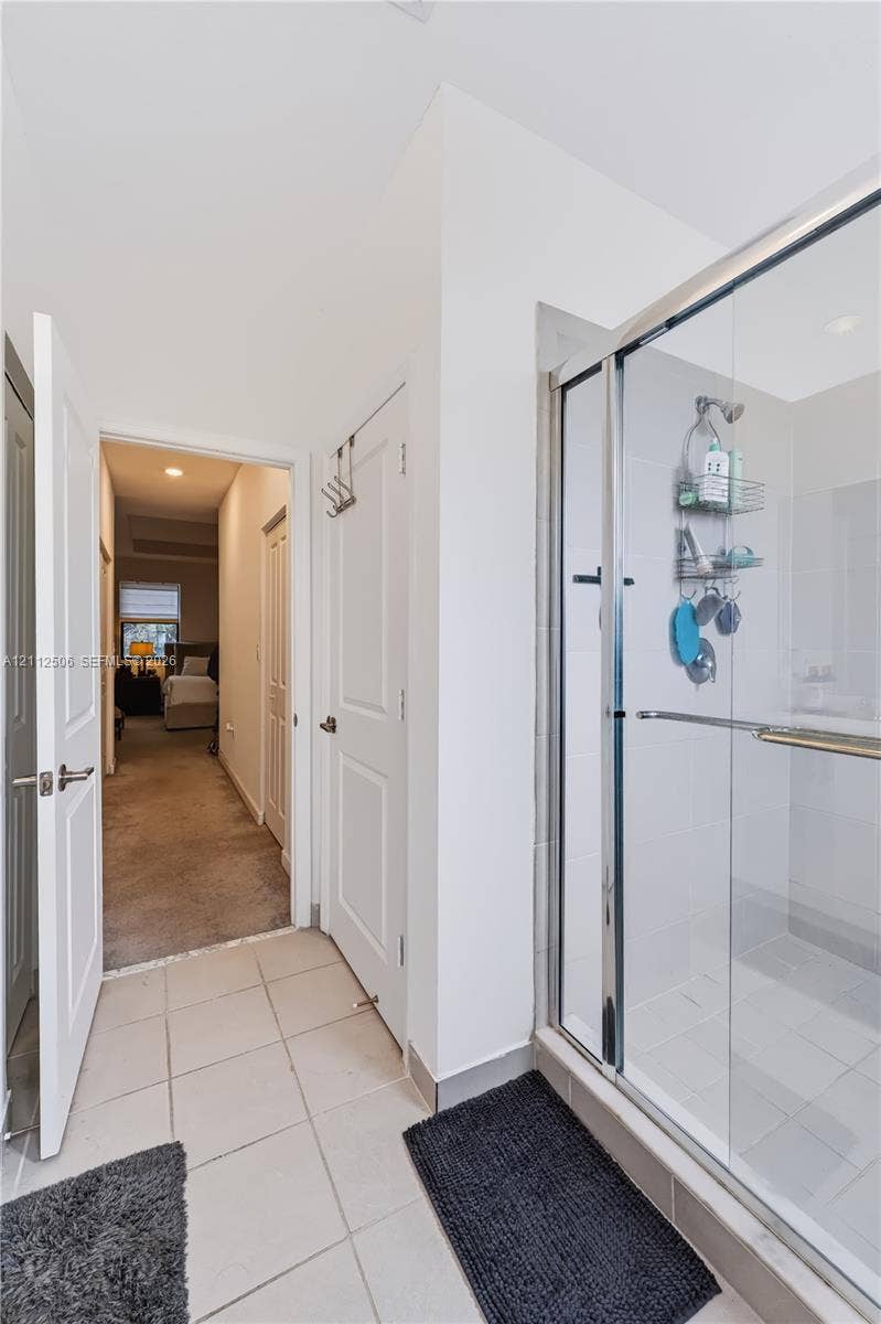 538 SW 19th Terrace, Fort Lauderdale, Fort Lauderdale, FL 33312 Walk-in shower featuring a glass enclosure, metal frame, and tile flooring