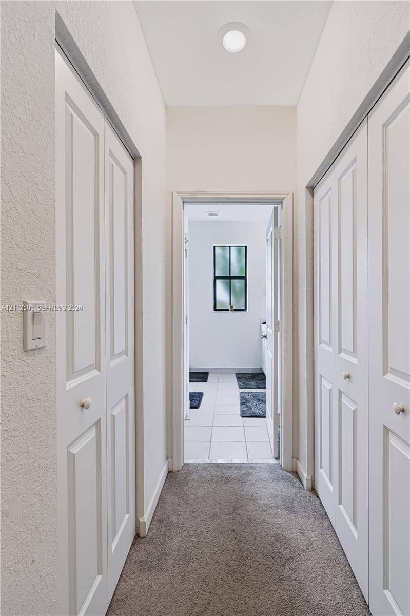 538 SW 19th Terrace, Fort Lauderdale, Fort Lauderdale, FL 33312 Hallway featuring neutral carpeting, dual white paneled bifold closets, and recessed ceiling lighting