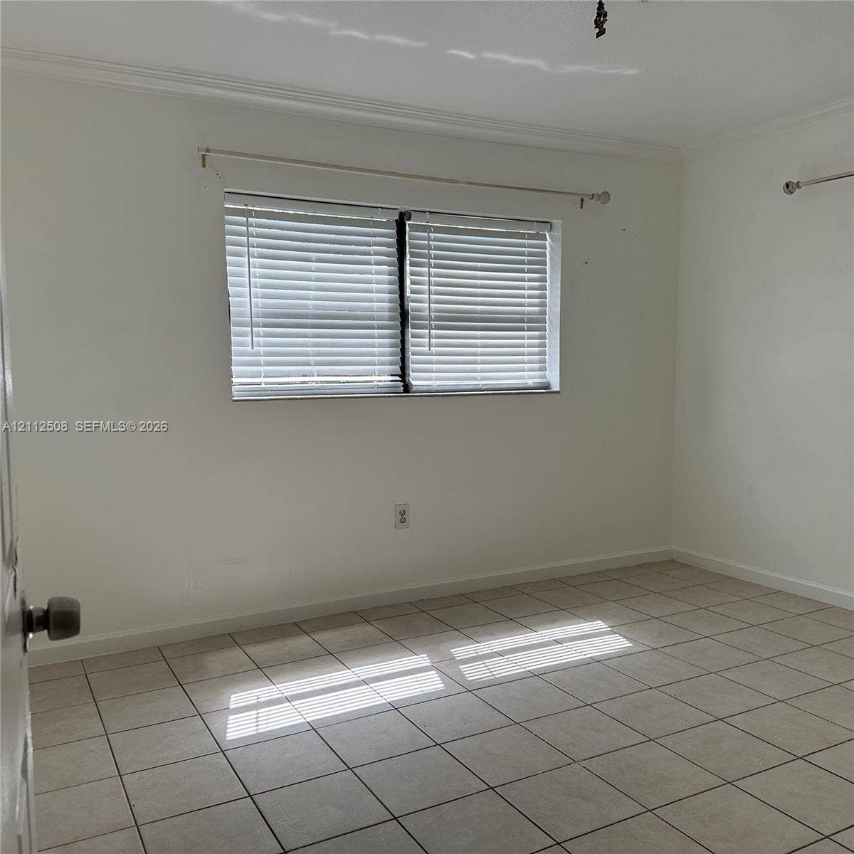 6432 Flagler Street, #1, Hollywood, Hollywood, FL 33023 Interior room featuring ceramic tile flooring, neutral wall paint, and a window with horizontal blinds