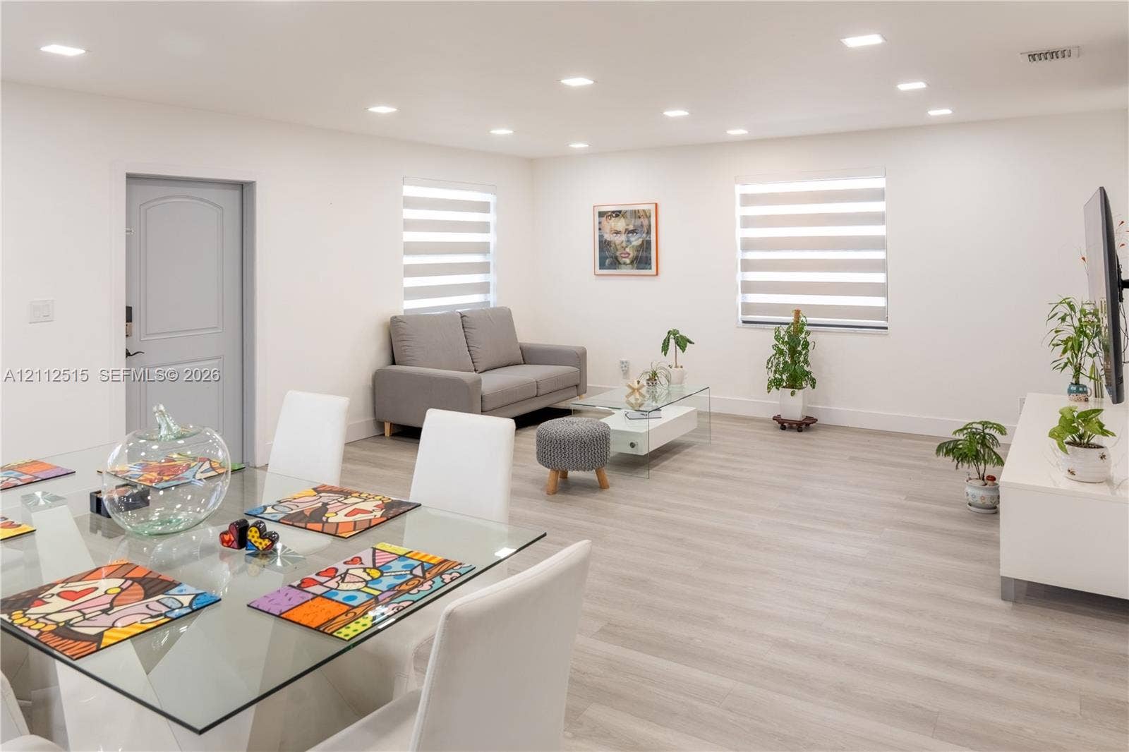 Hallandale Beach, FL 33009 Open-concept living space featuring wood-finish flooring, recessed lighting, and banded window shades