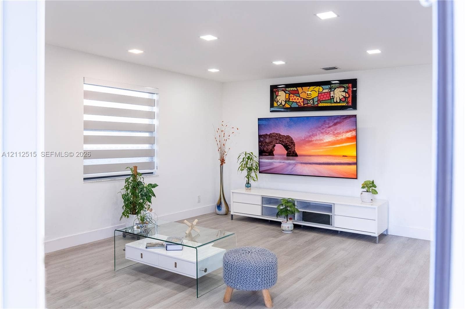 Hallandale Beach, FL 33009 Neutral-toned room featuring wood-finish flooring, recessed lighting, and tiered window shades
