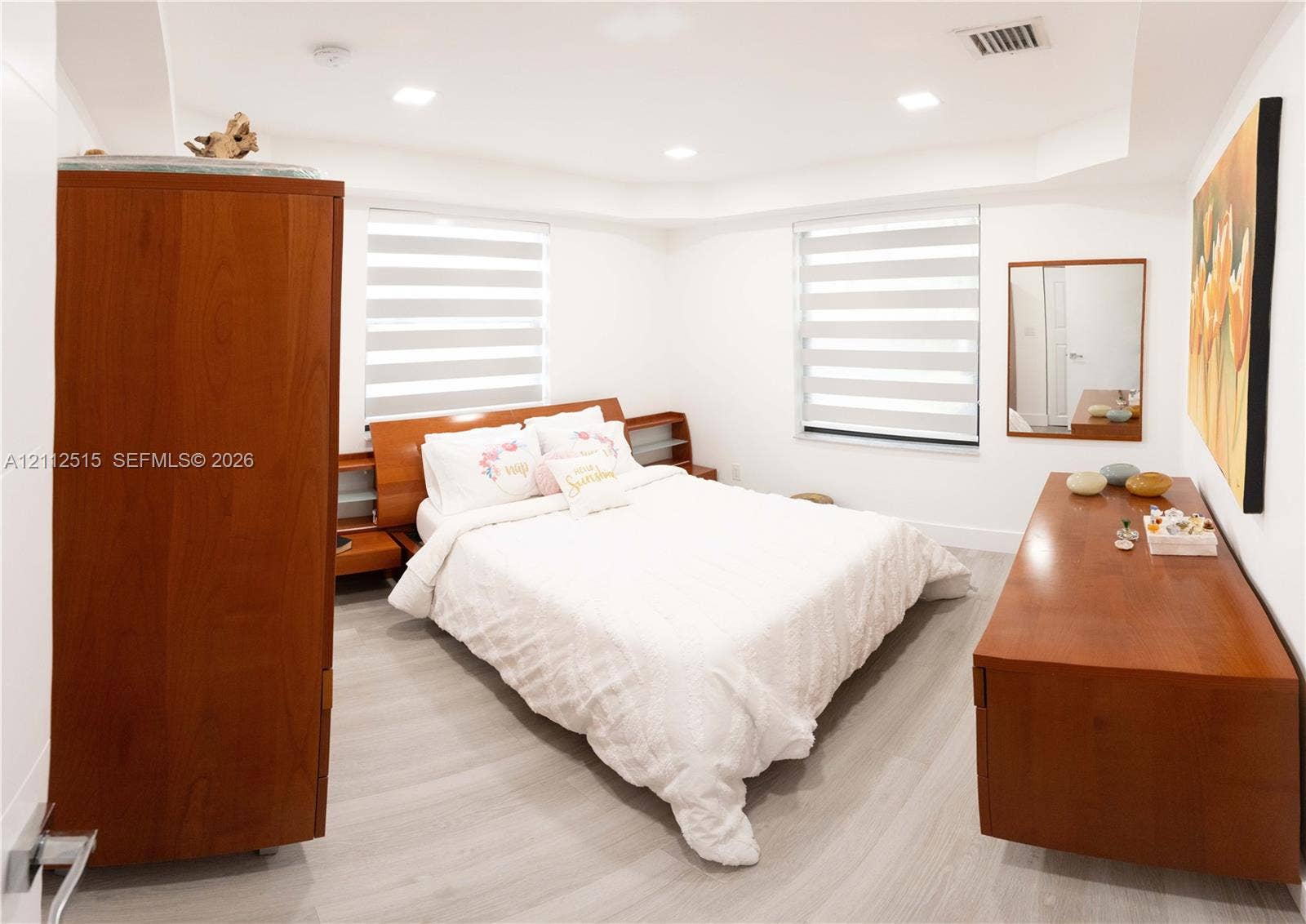 Hallandale Beach, FL 33009 Neutral-toned wood-finish flooring, recessed ceiling lighting, and dual-layered window shades