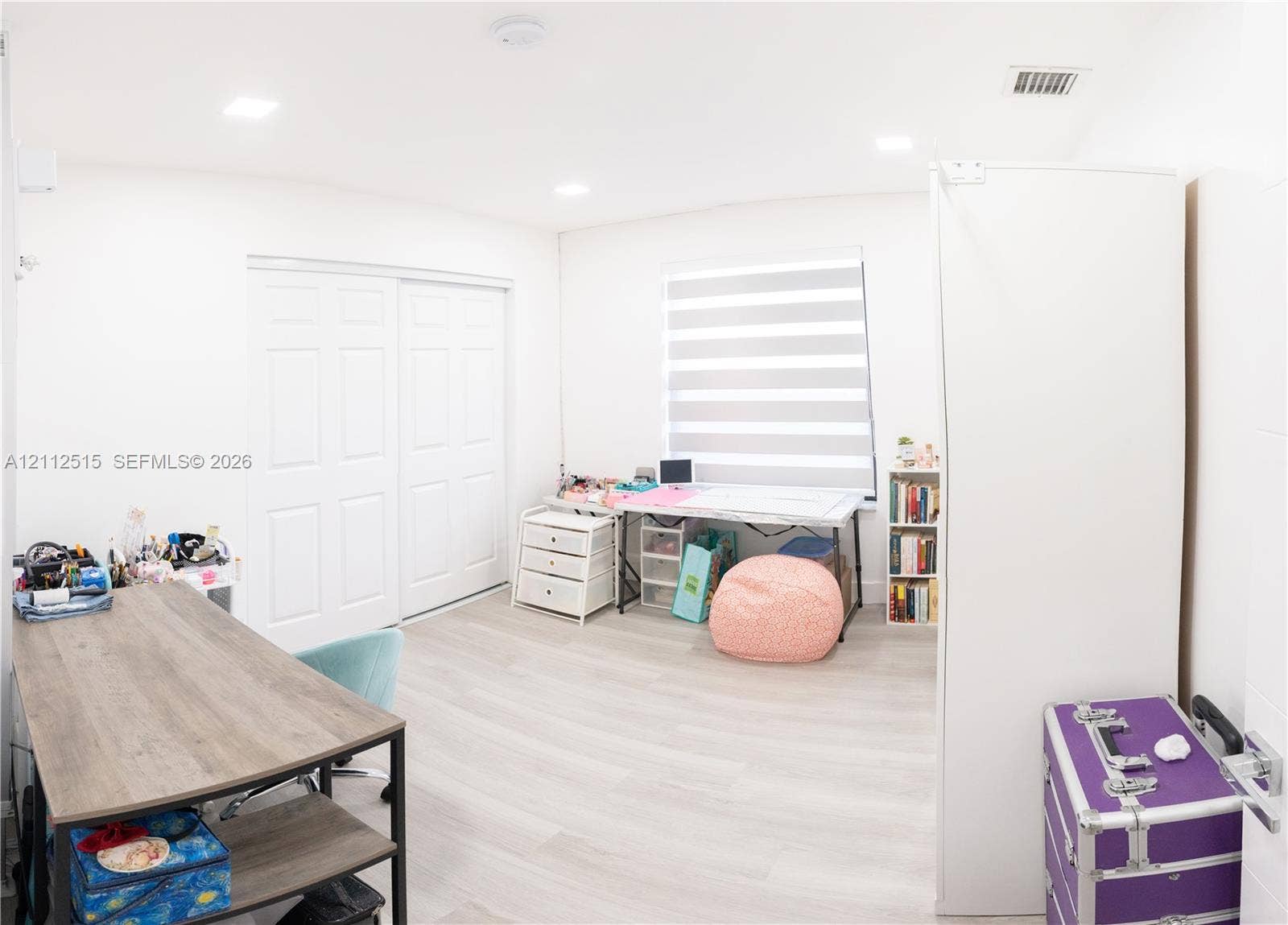 Hallandale Beach, FL 33009 Interior space featuring wood-finish flooring, recessed lighting, and dual-panel closet doors with adjustable window shades