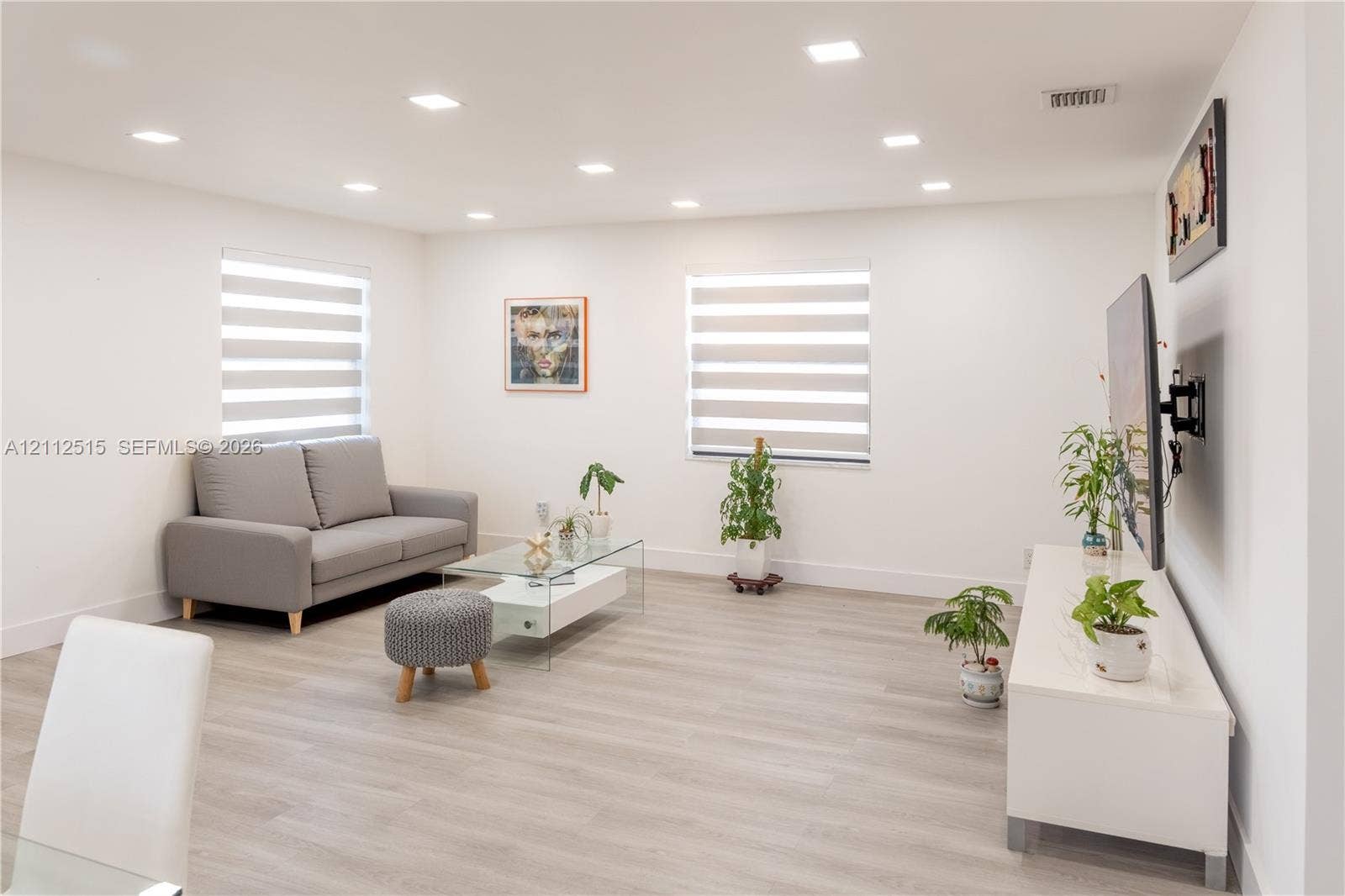 Hallandale Beach, FL 33009 Interior space featuring wood-finish flooring, recessed lighting, and dual windows with integrated privacy shades