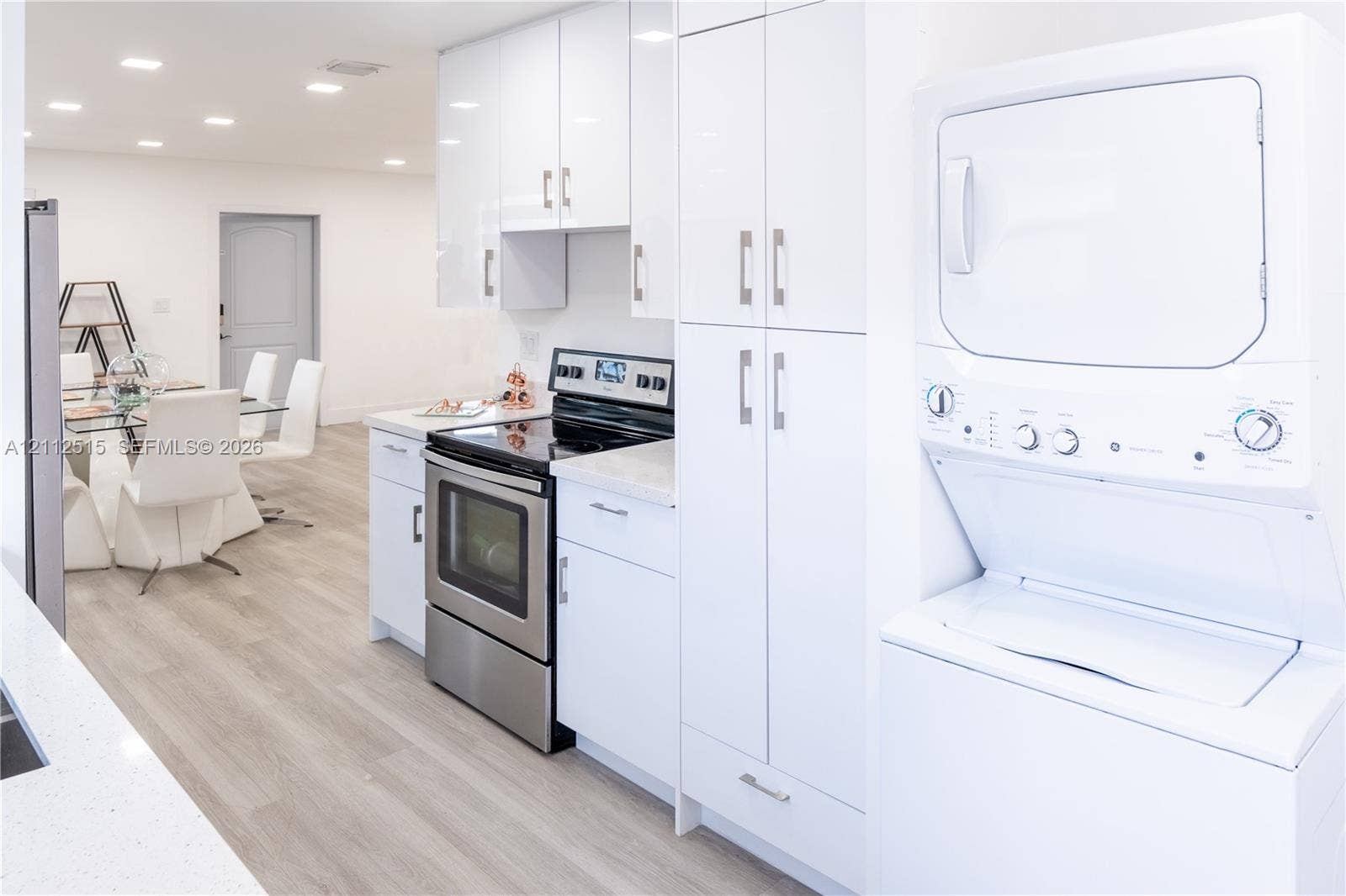 Hallandale Beach, FL 33009 Kitchen featuring high-gloss white cabinetry, stone-finish countertops, stainless steel electric range, recessed ceiling lighting, and wood-finish flooring