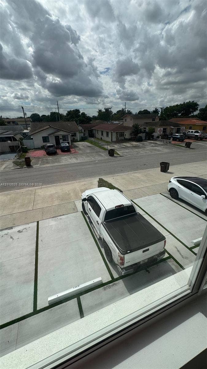 351 E 14th Street, #353, Hialeah, Hialeah, FL 33010 Designated surface parking area featuring concrete paving and individual stall dividers