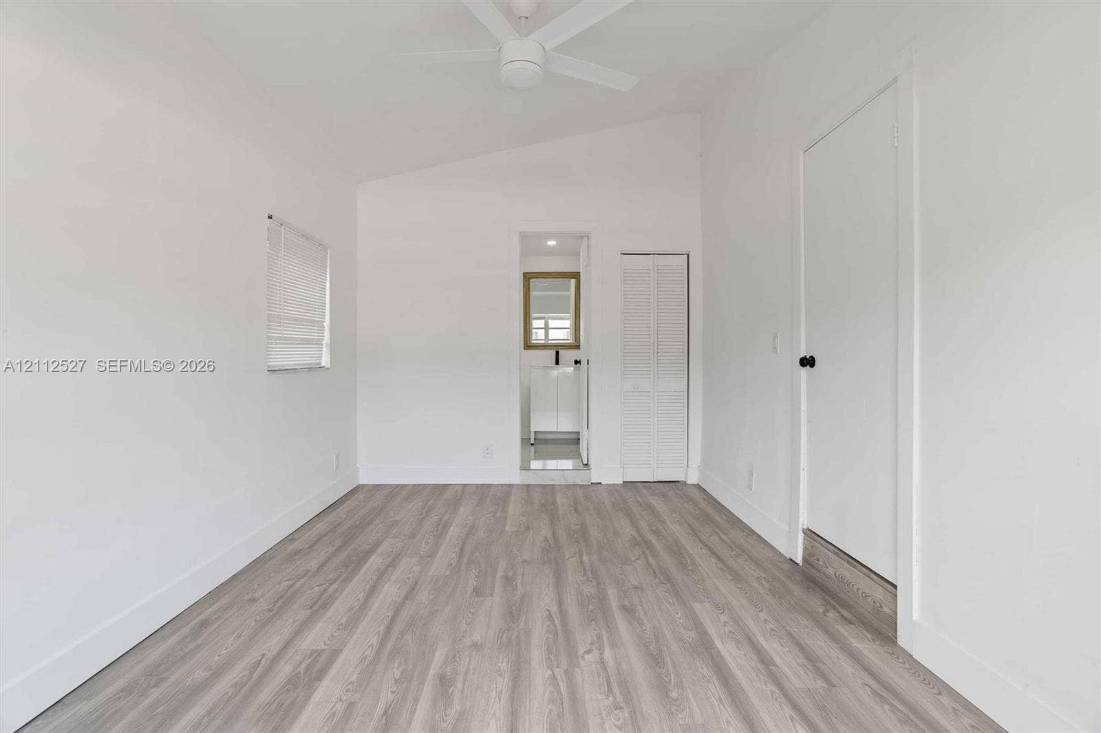 2517 Polk Street, Hollywood, Hollywood, FL 33020 Vaulted ceilings, wood-finish flooring, ceiling fan, and louvered closet doors