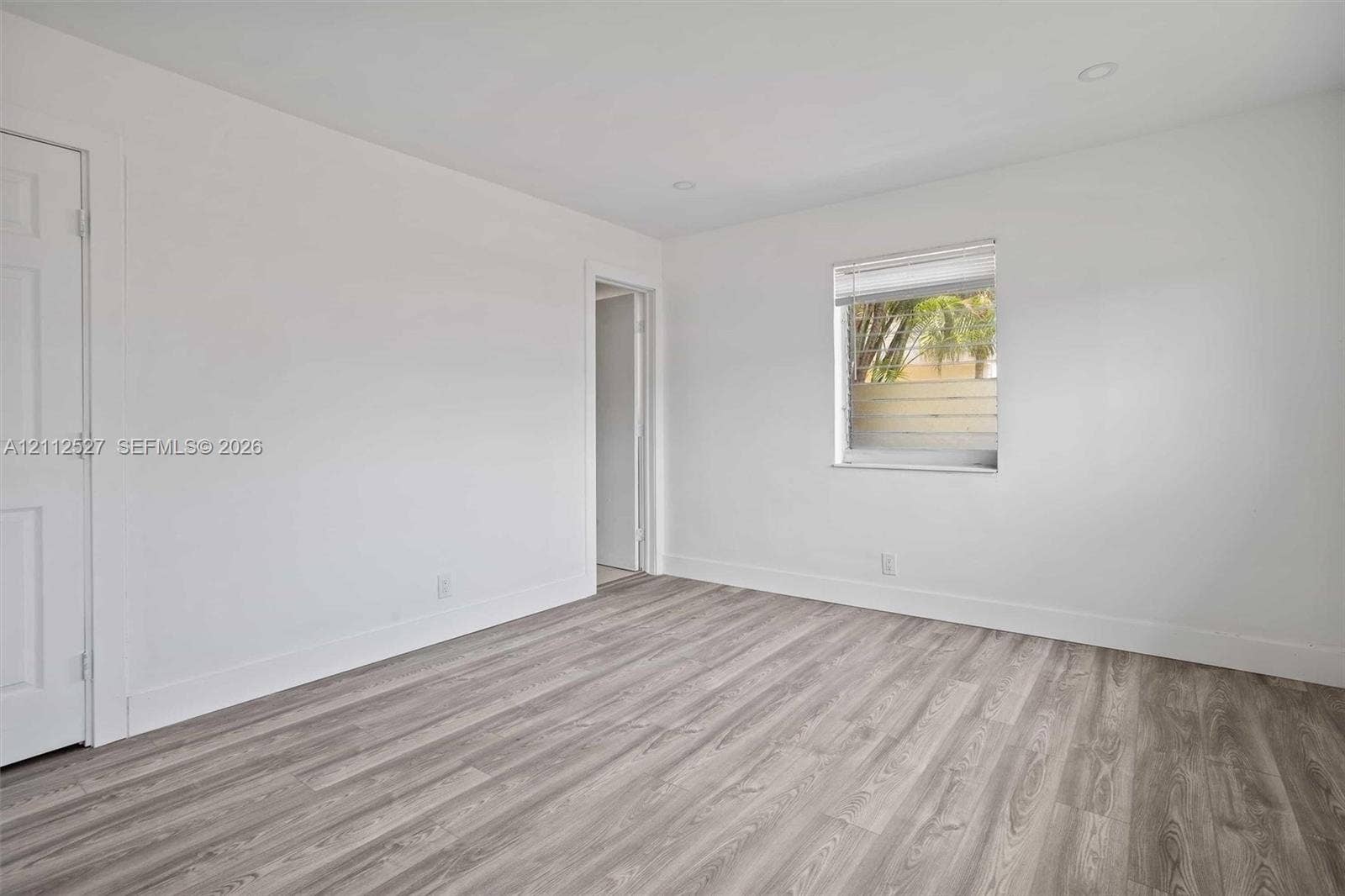 2517 Polk Street, Hollywood, Hollywood, FL 33020 Neutral-toned interior featuring wood-finish flooring, recessed lighting, and a single-pane window