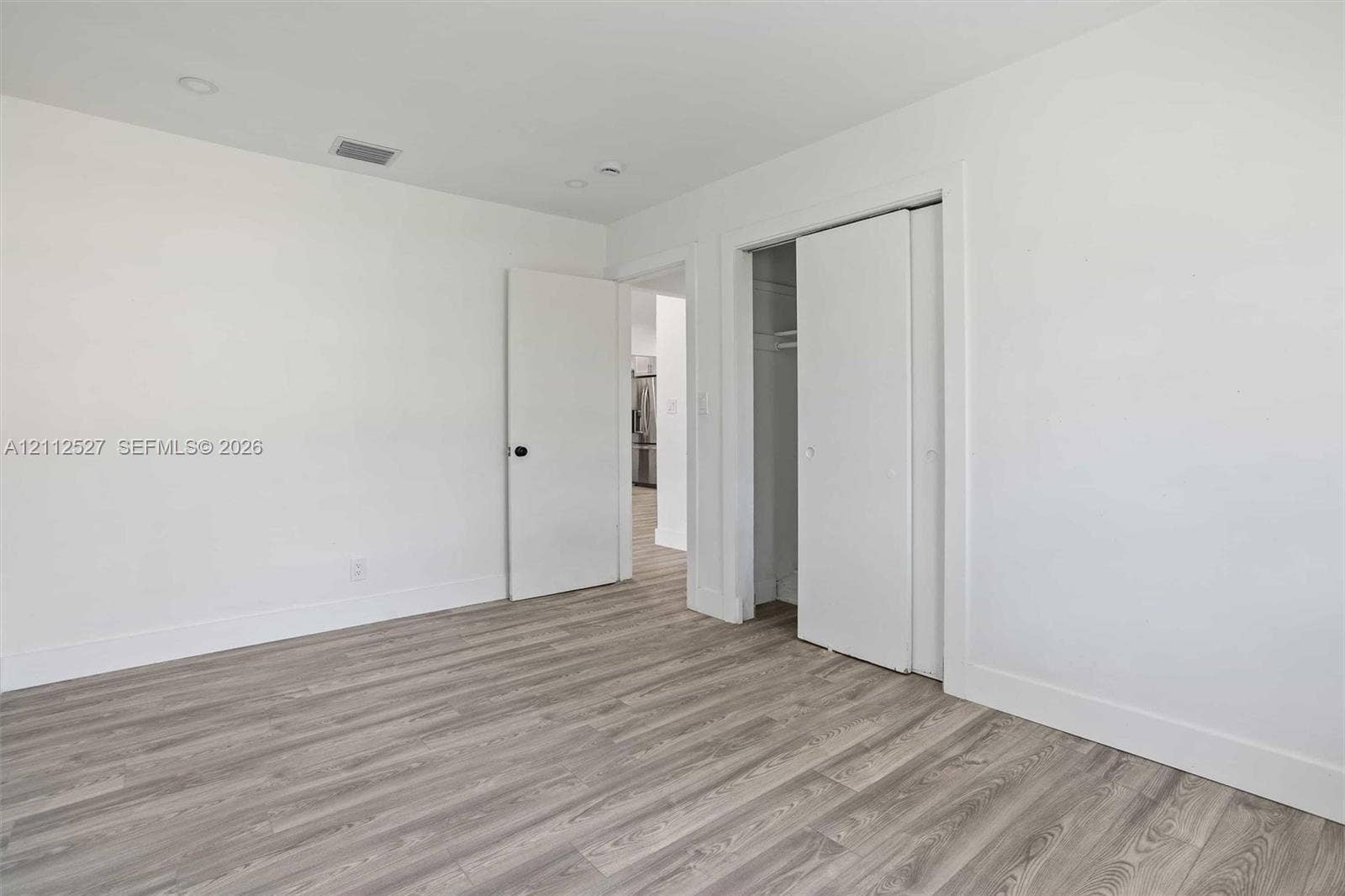 2517 Polk Street, Hollywood, Hollywood, FL 33020 Interior space featuring wood-finish flooring, neutral walls, recessed lighting, and a closet with sliding doors