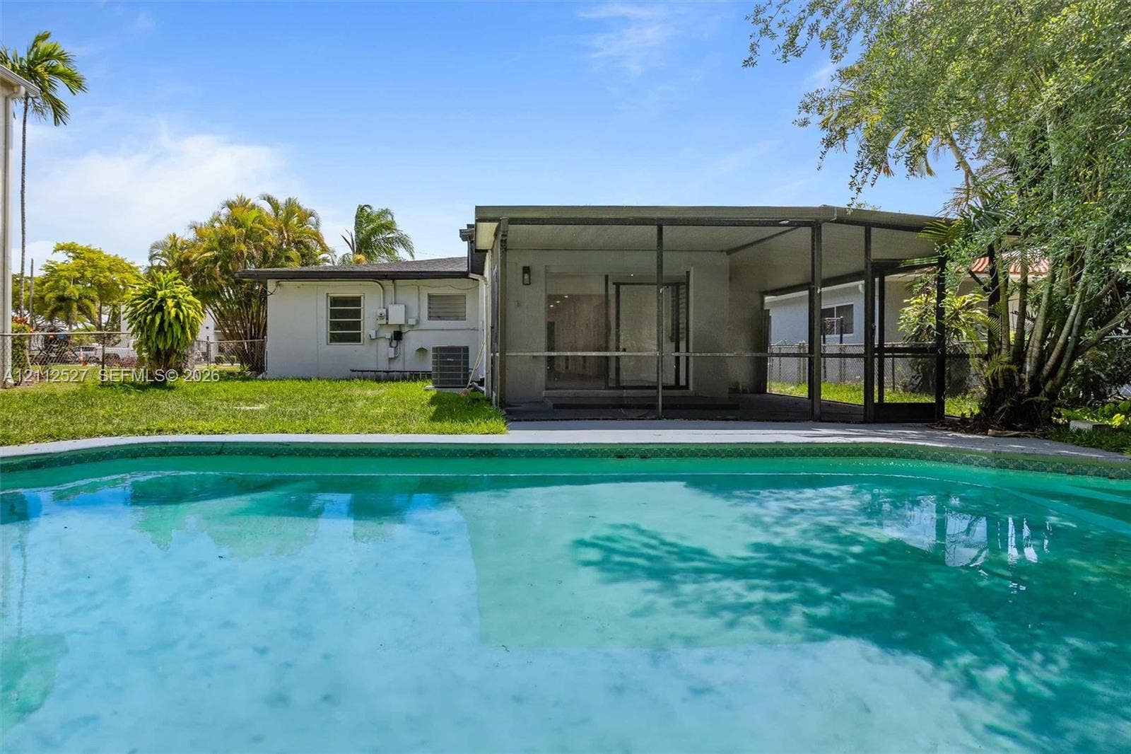 2517 Polk Street, Hollywood, Hollywood, FL 33020 In-ground swimming pool featuring a concrete deck, screened-in lanai, and landscaped backyard