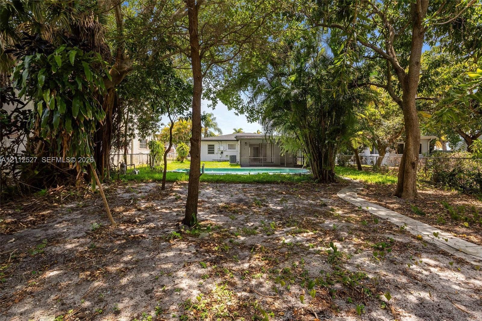 2517 Polk Street, Hollywood, Hollywood, FL 33020 Backyard featuring an in-ground swimming pool, concrete paver pathway, and mature trees