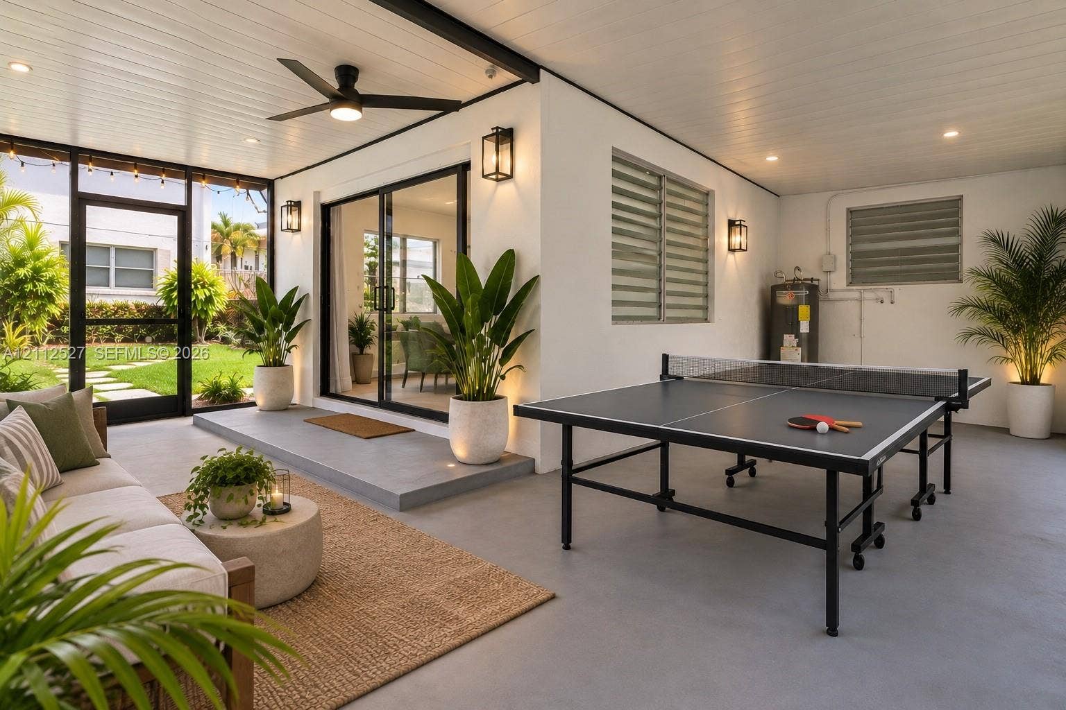 2517 Polk Street, Hollywood, Hollywood, FL 33020 Covered outdoor living space featuring a concrete patio, recessed ceiling lighting, a ceiling fan, sliding glass doors, and louvered windows