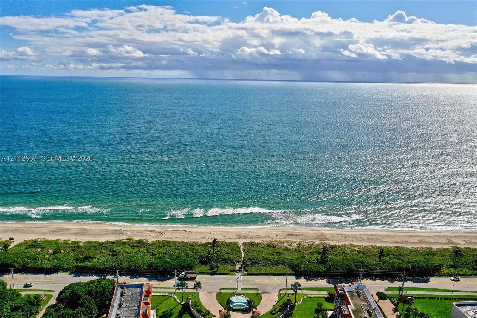 2871 N Ocean Boulevard, #R360, Boca Raton, FL 33431 Direct oceanfront exposure with panoramic water scenery, sandy beach access, and coastal landscaping