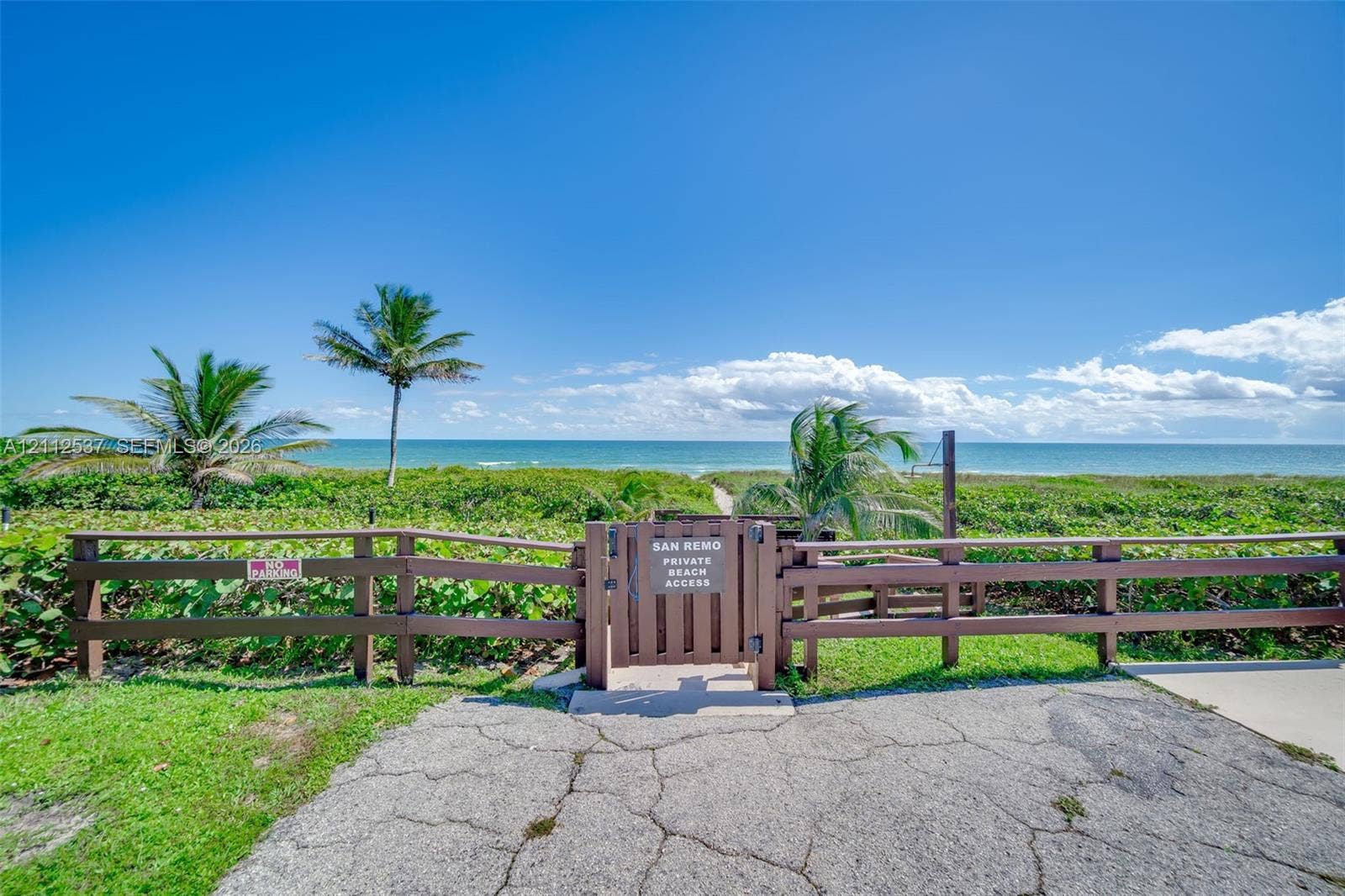2871 N Ocean Boulevard, #R360, Boca Raton, FL 33431 Private beach access featuring a wood-style perimeter fence, secure gate, and tropical landscaping