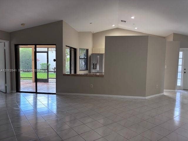 Vaulted ceilings, ceramic tile flooring, sliding glass doors to a screened lanai, and recessed lighting