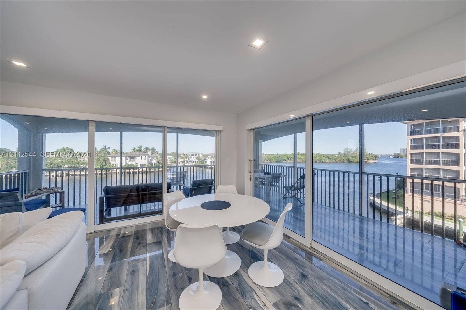 2871 N Ocean Boulevard, #R360, Boca Raton, Boca Raton, FL 33431 Expansive floor-to-ceiling glass sliding doors, wood-finish flooring, recessed lighting, and a wrap-around balcony with metal railing