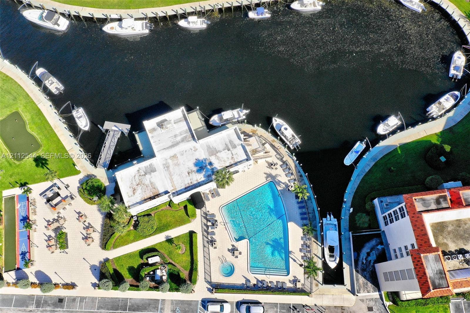 2871 N Ocean Boulevard, #R360, Boca Raton, Boca Raton, FL 33431 Aerial perspective of a waterfront property featuring a swimming pool, integrated spa, private boat slips, and paved terrace area
