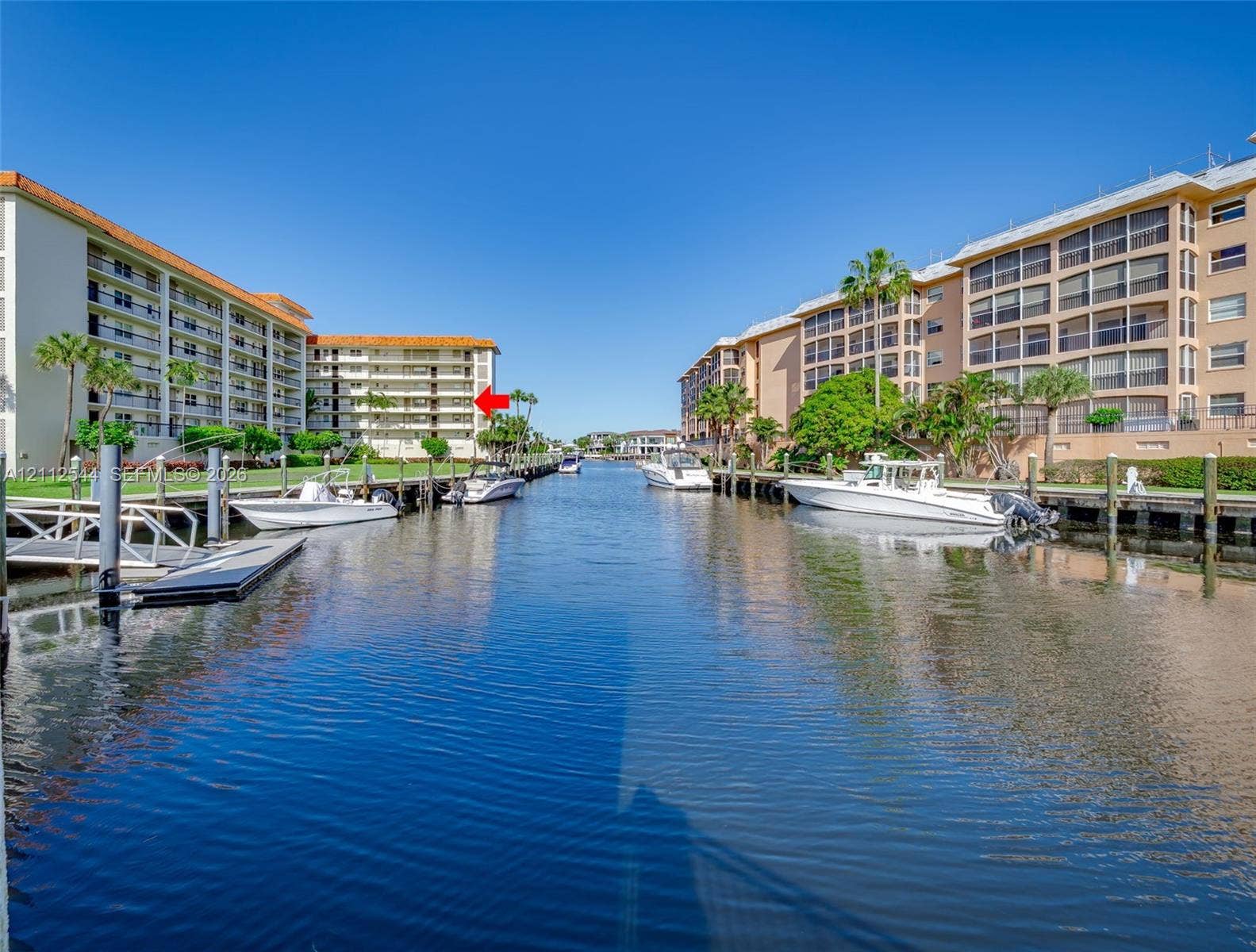 2871 N Ocean Boulevard, #R360, Boca Raton, Boca Raton, FL 33431 Waterfront condominium complex featuring concrete boat slips, direct canal access, and landscaped grounds