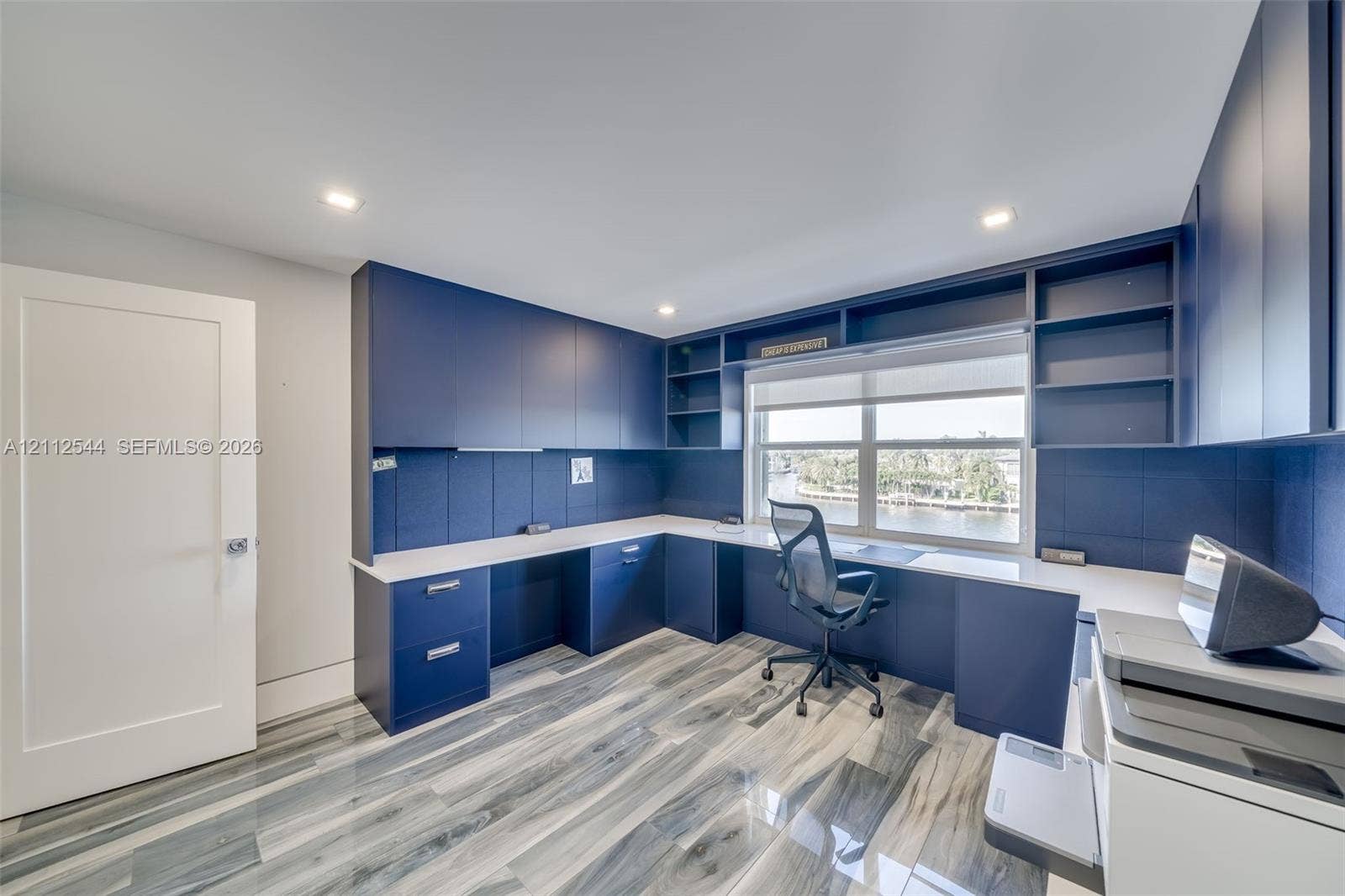 2871 N Ocean Boulevard, #R360, Boca Raton, Boca Raton, FL 33431 Custom built-in navy cabinetry with integrated shelving and drawers, light-toned countertop, and patterned wood-finish flooring