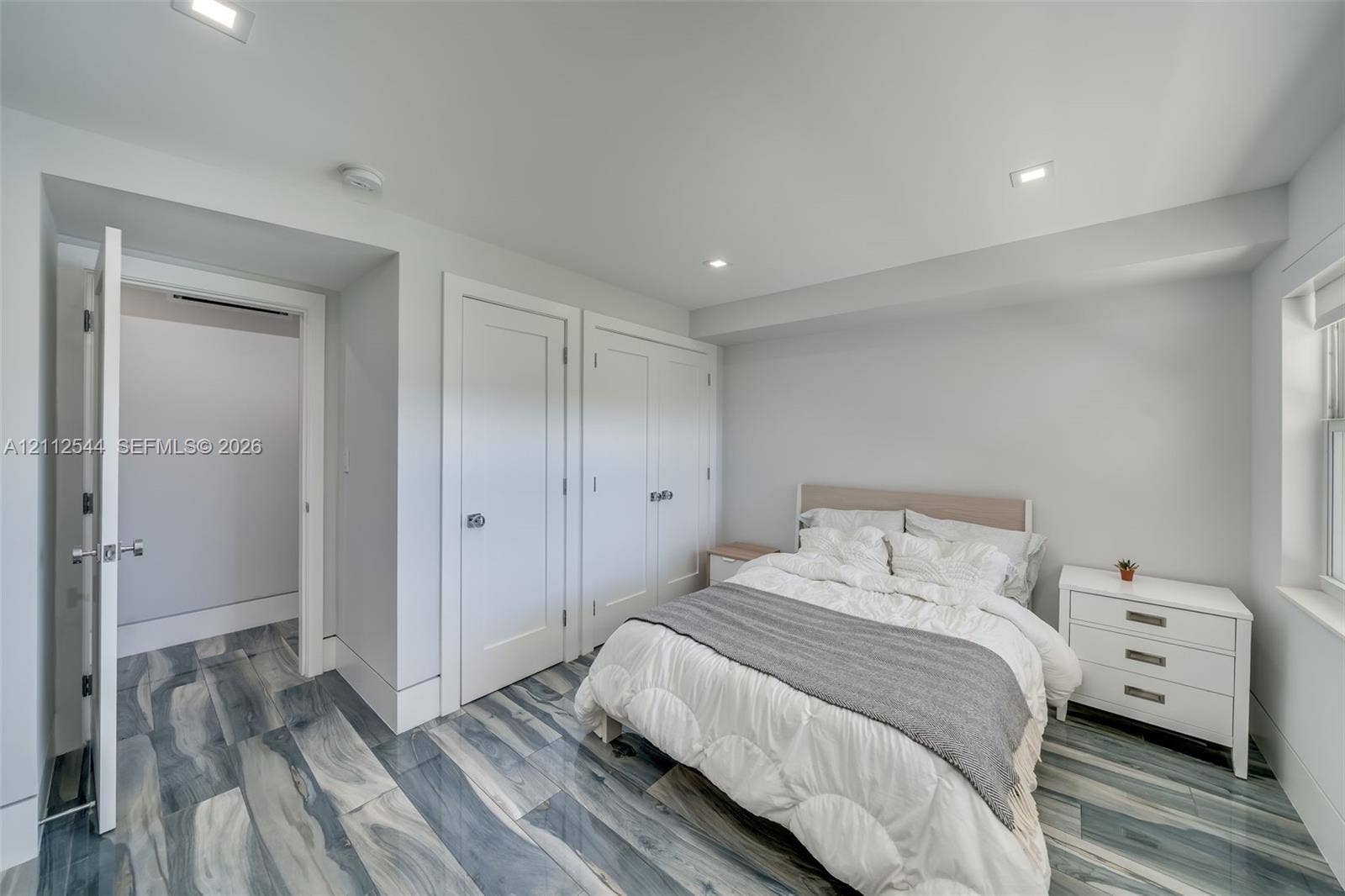 2871 N Ocean Boulevard, #R360, Boca Raton, Boca Raton, FL 33431 Interior room featuring high-gloss, blue and grey vein-patterned flooring, recessed ceiling lighting, and double shaker-style closet doors