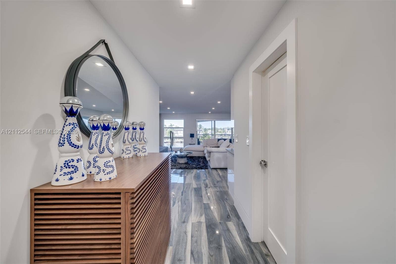 2871 N Ocean Boulevard, #R360, Boca Raton, Boca Raton, FL 33431 Hallway featuring high-gloss, wood-finish flooring, recessed ceiling lighting, and a minimalist door with a polished metallic handle