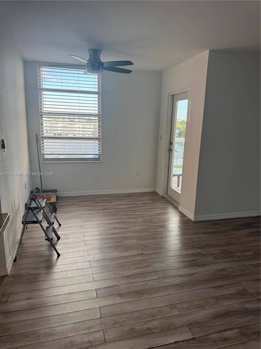 1301 NE Miami Gardens Drive, #515W, Miami, Miami, FL 33179 Wood-finish flooring, multi-pane window with horizontal blinds, ceiling fan, and glass-paneled exterior door