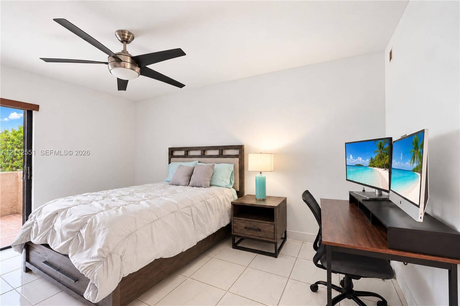 Ceramic tile flooring, multi-blade ceiling fan with integrated lighting, and sliding glass door with access to exterior balcony