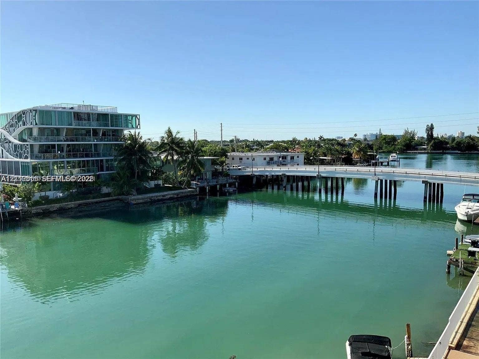8400 Byron Avenue, #4E, Miami Beach, Miami Beach, FL 33141 Waterfront setting with direct canal access, concrete seawall, and mature palm trees