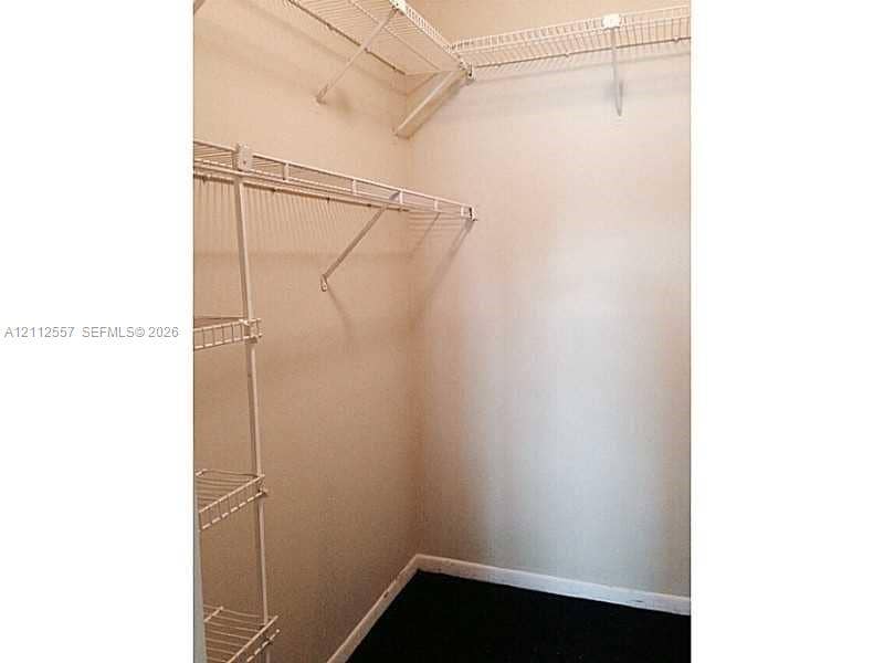 2121 NW 96th Terrace, #14J, Pembroke Pines, Pembroke Pines, FL 33024 Walk-in storage space featuring white wire shelving units and dark flooring