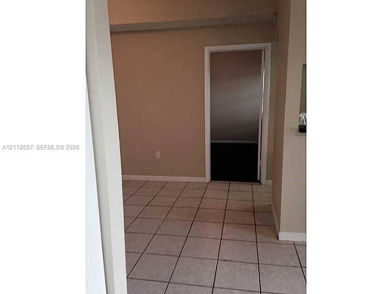 2121 NW 96th Terrace, #14J, Pembroke Pines, Pembroke Pines, FL 33024 Interior space featuring neutral-toned walls and light-colored square tile flooring
