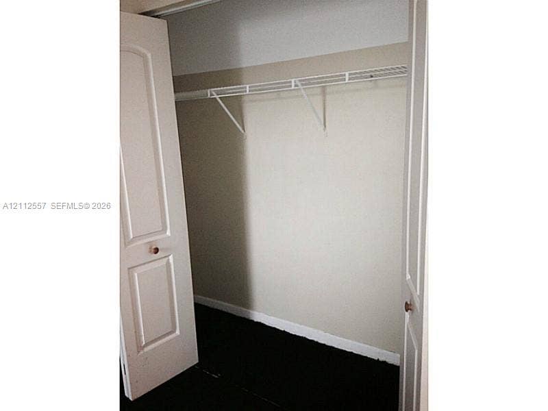 2121 NW 96th Terrace, #14J, Pembroke Pines, Pembroke Pines, FL 33024 Storage closet featuring white paneled bifold doors and a built-in wire shelving unit